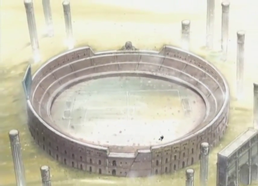 Screenshot of a frame showing the ruins of an amphitheatre-like structure along with other classical architectural elements in a sandy desert landscape seen from above