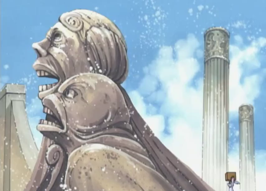 Screenshot of a frame showing some stuccoed nightmarish statues on a side of an amphitheatre-like structure